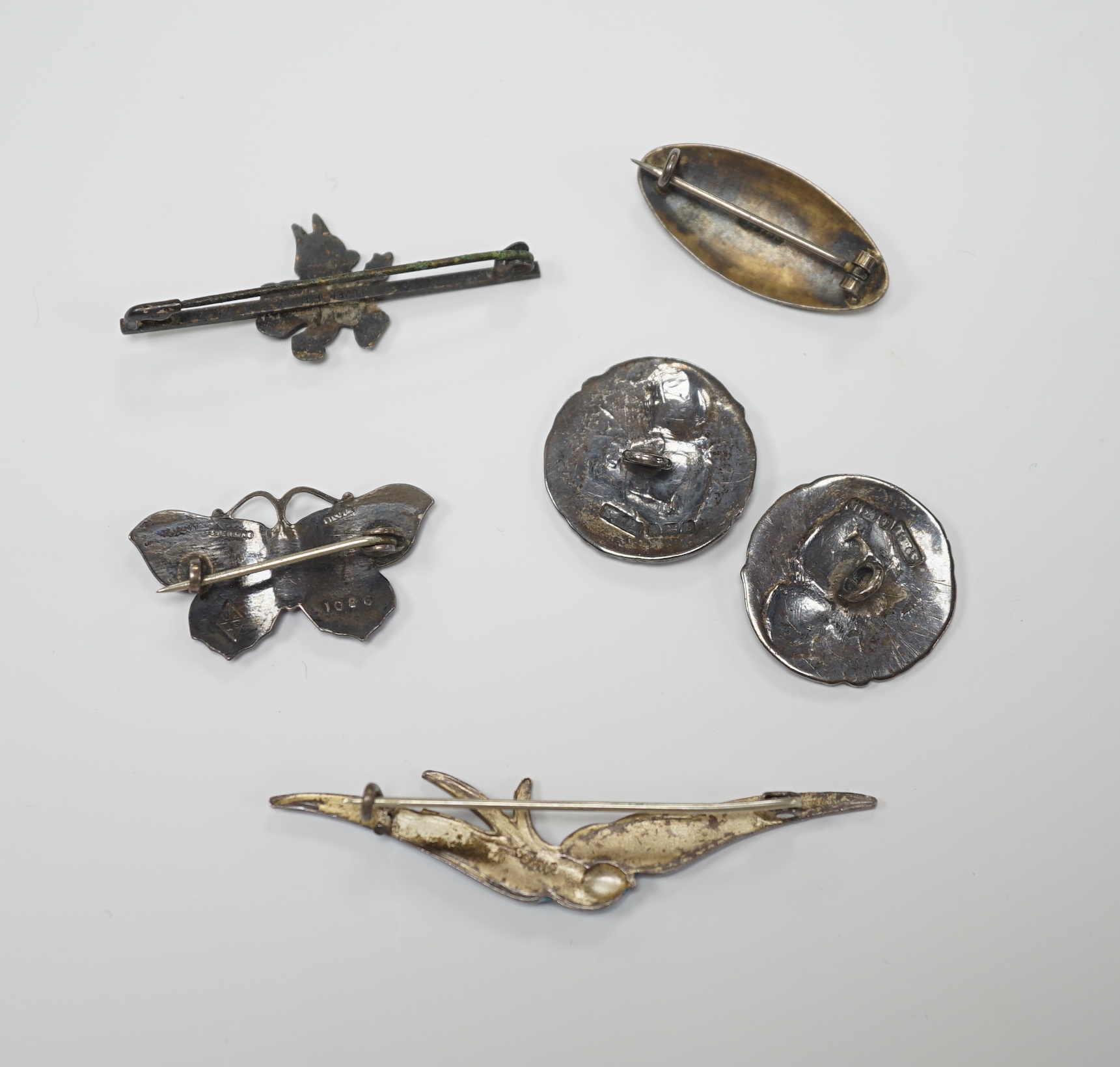 A Norwegian 925S and two colour enamel oval brooch, 28mm, a sterling and three colour enamel butterfly brooch, a white metal (stamped silver) and enamel swallow brooch, a pair of Edwardian Art Nouveau silver buttons and